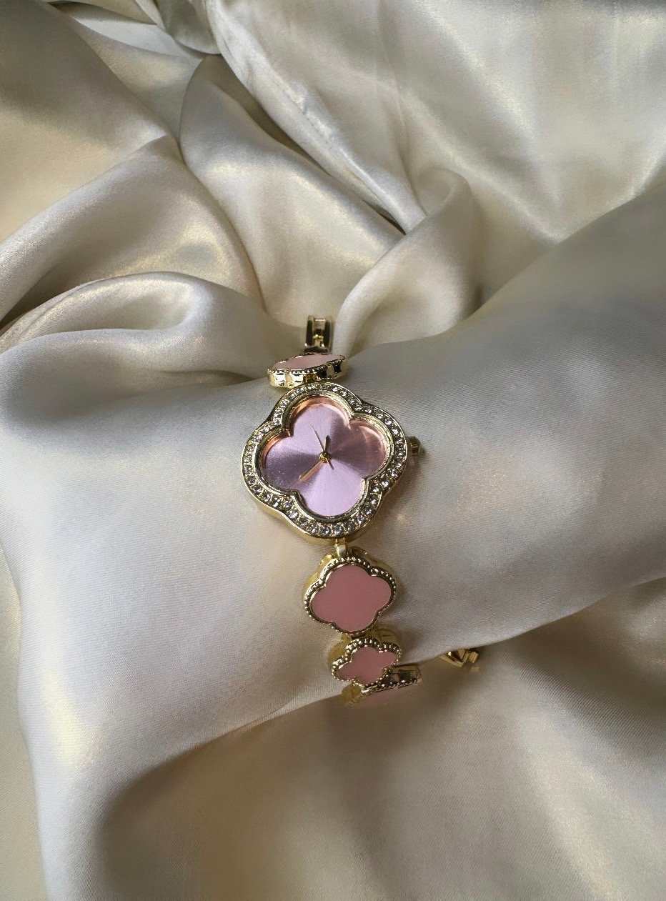 Clover watch pink Pink clover-shaped watch with gold-tone finish and adjustable bracelet.