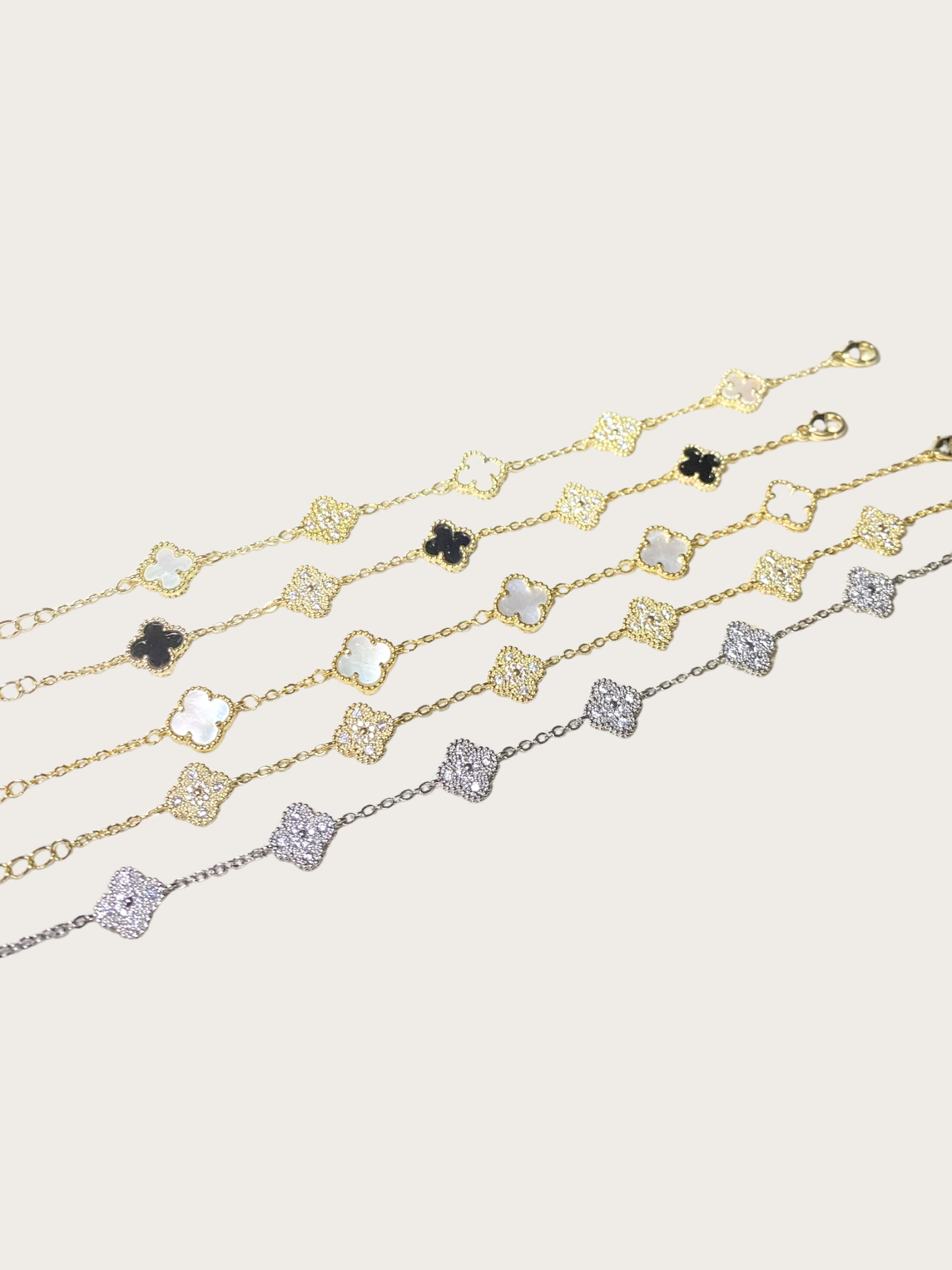 Rojin bracelets Gold and silver bracelet with clover charms in various colors