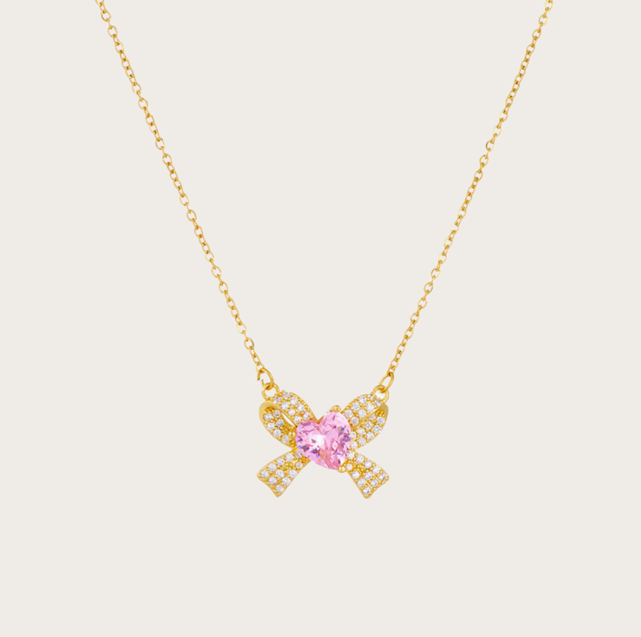 2 kopie Elegant Nayla Bow Necklace in 18K gold-plated stainless steel with a zircon bow and pink heart.